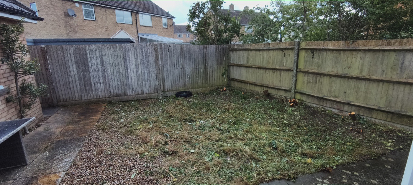 After photo of rear garden cleared and hedge cut back